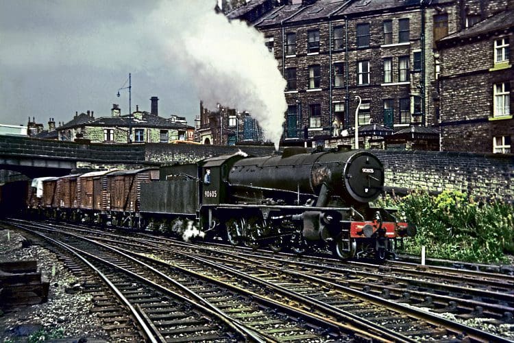 Royston-based WD Austerity 2-8-0 No. 90605, one of the last locomotives to be overhauled at Cowlairs, heads an eastbound freight into Shipley on August 31, 1966. DAVE RODGERS